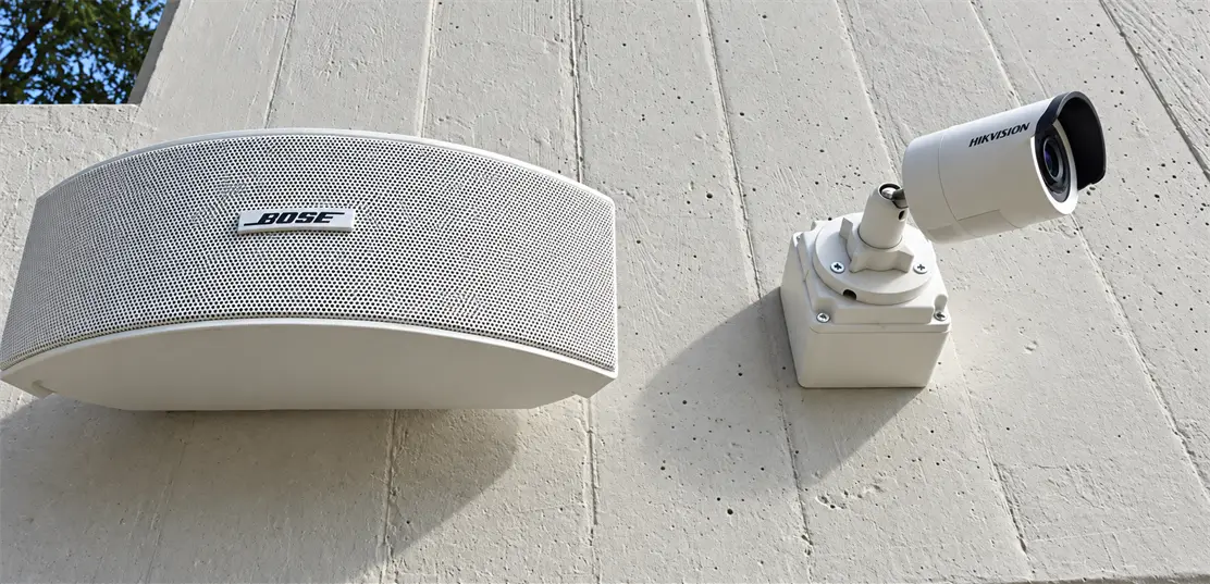 Outdoor speaker installed on an exterior wall