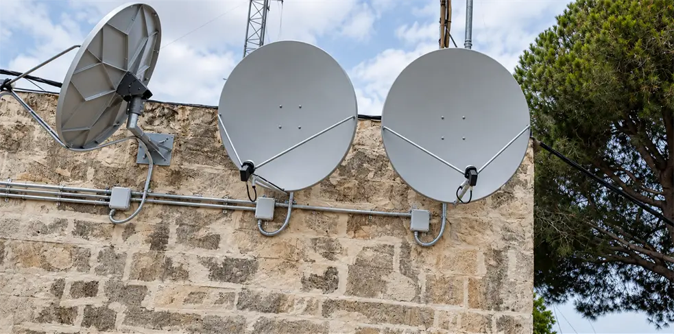 Rooftop satellite dishes for a SMATV system